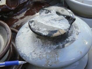 Fine-grained tephra adhered under a 33 kV porcelain insulator in Fu...