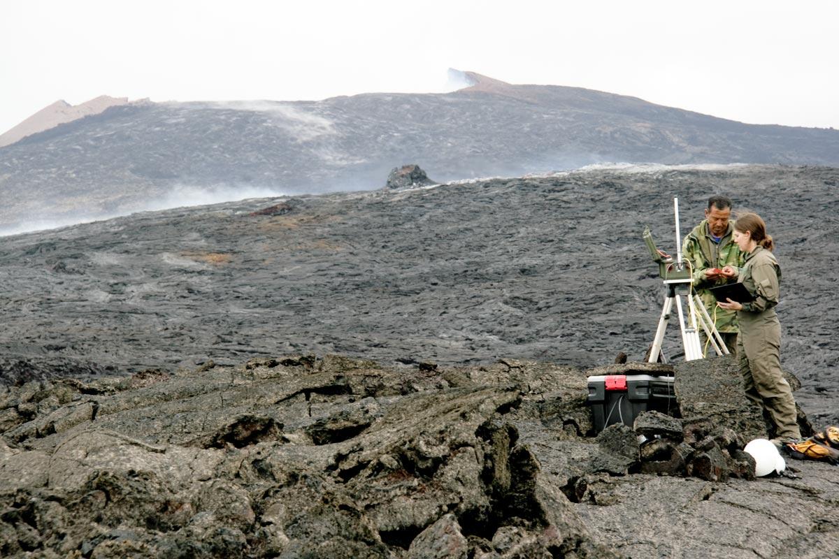 HVO geologist and helicopter pilot repair a mobile Webcam on Kupaia...