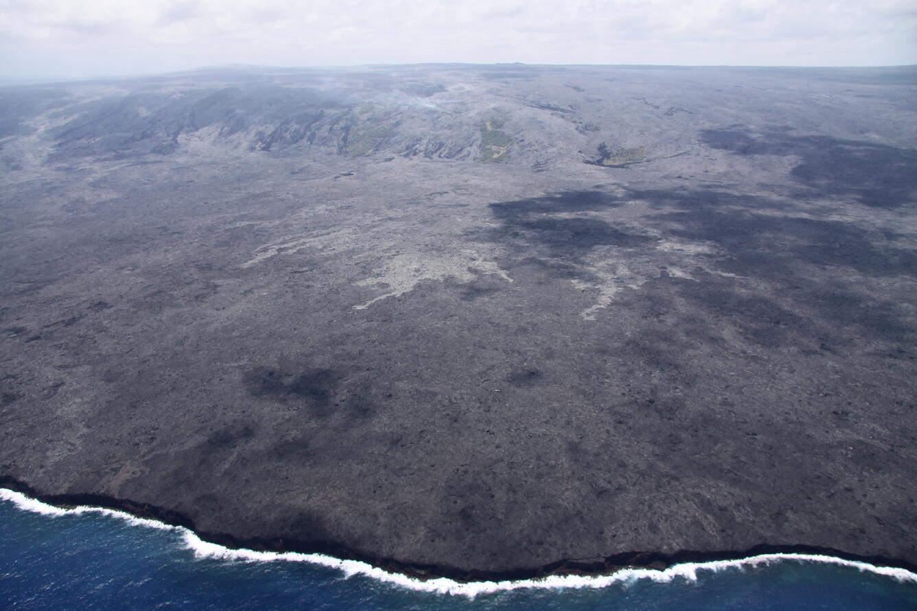 Coastal plain flows still slowly advancing towards ocean; lava pond...