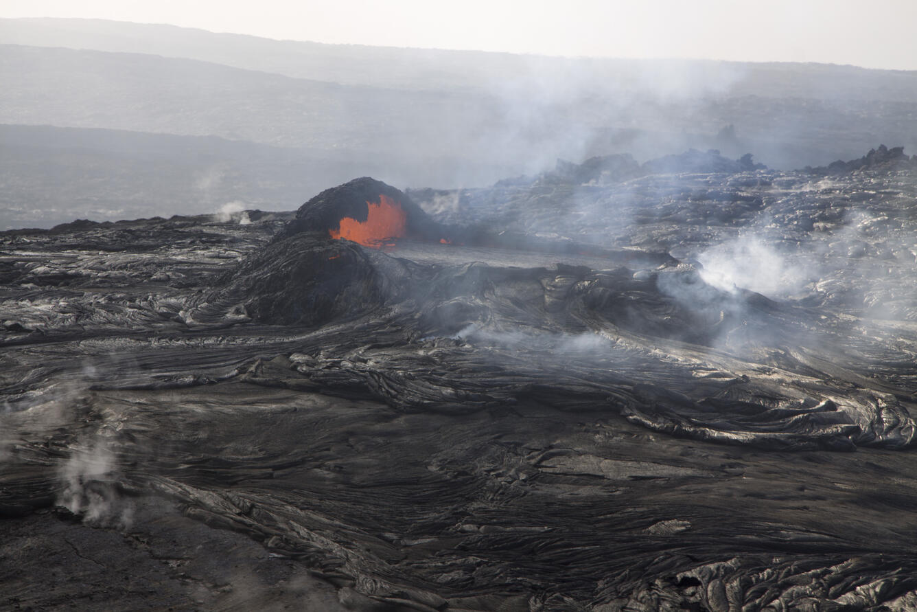 This photo, looking south, shows lava spilling from the small, perc...