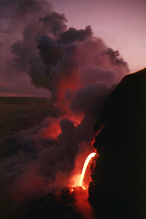 Lava pours from tube into sea, Kīlauea Volcano, Hawai‘i...