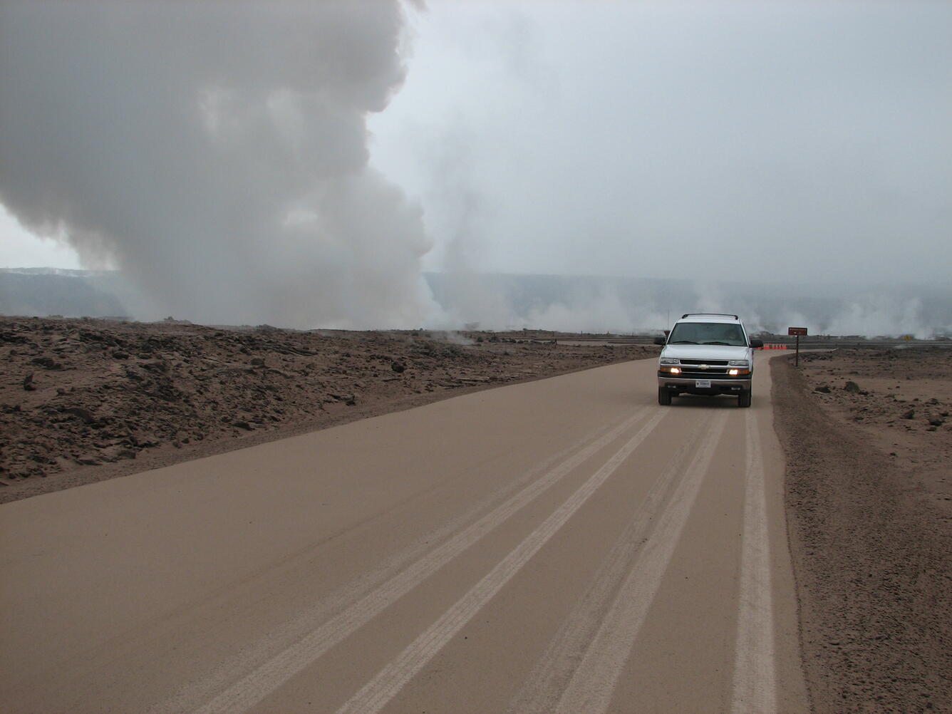 Volcanic ash covers Crater Rim Drive near Halema‘uma‘u Crater, Kīla...