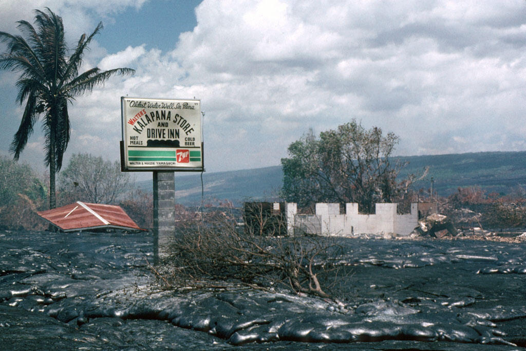 Lava flows around Walter's Drive Inn sign in Kalapana, Kīlauea Volc...