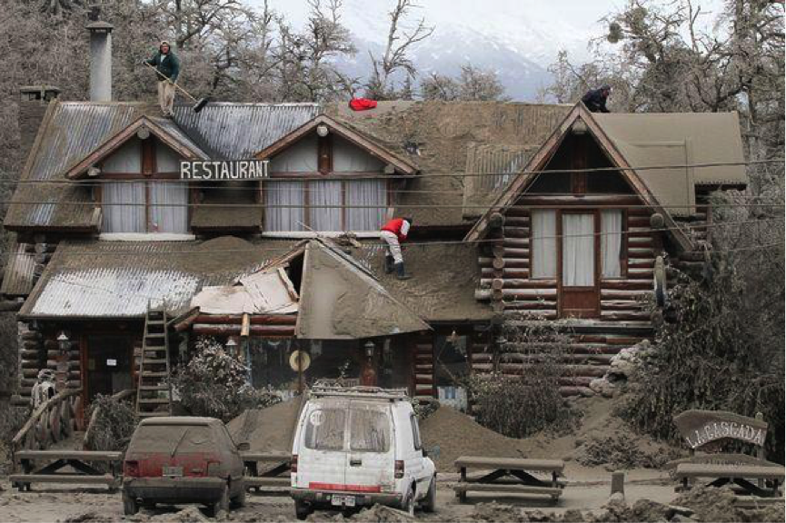 Workers removing ash of a restaurant in Villa La Angostura on June ...