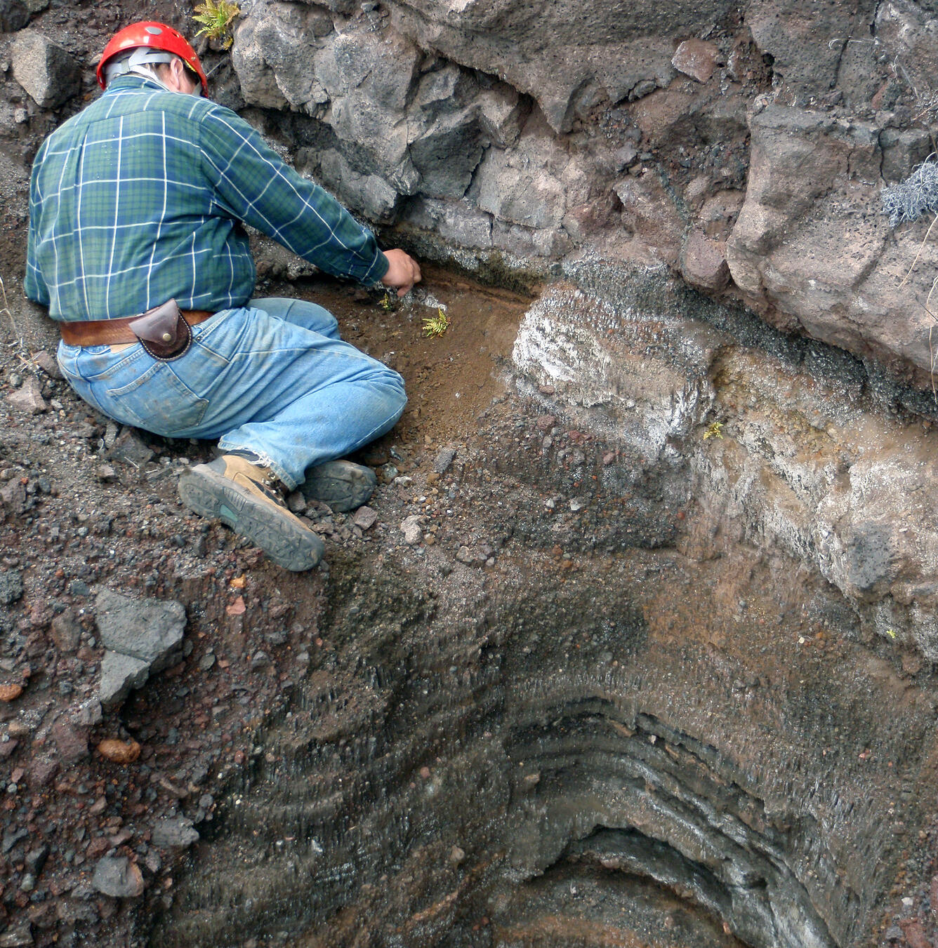 Geologist samples layers formed by explosive eruptions at Kīlauea V...