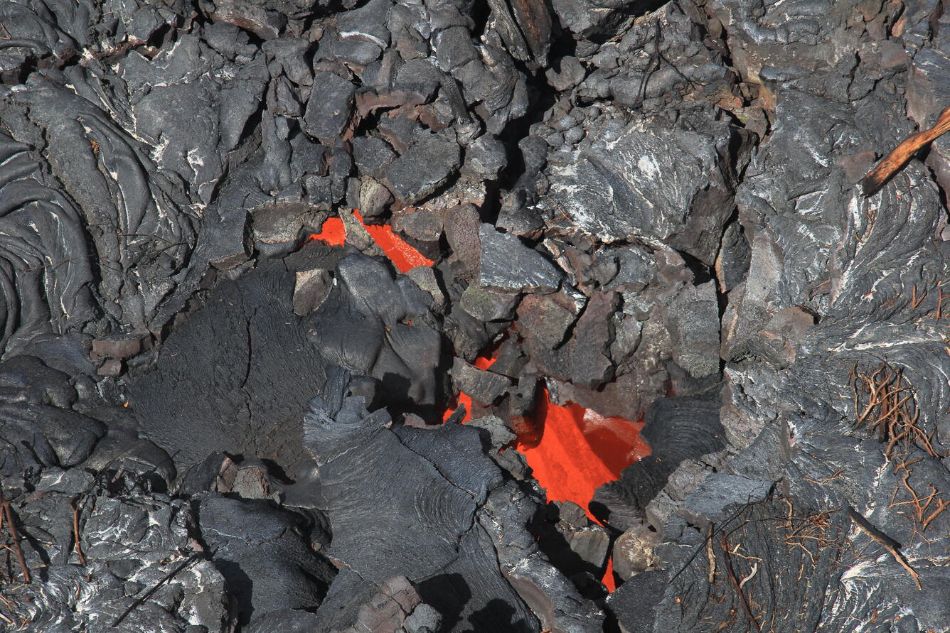 A closer look at the lava stream plunging into the crack. The lava...