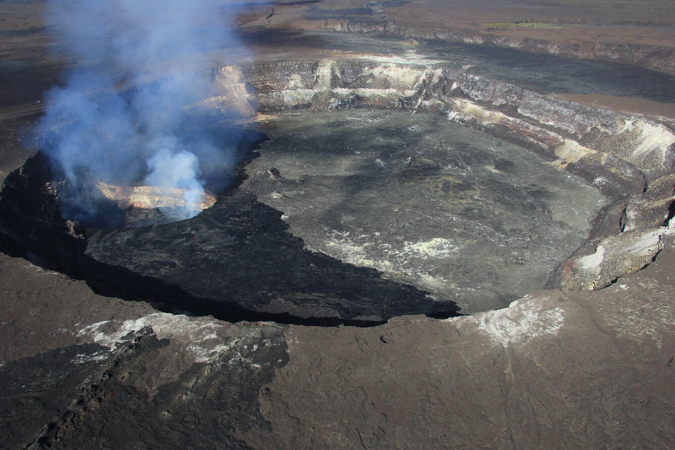 Halema‘uma‘u Crater, looking west. The dark area on the crater flo...