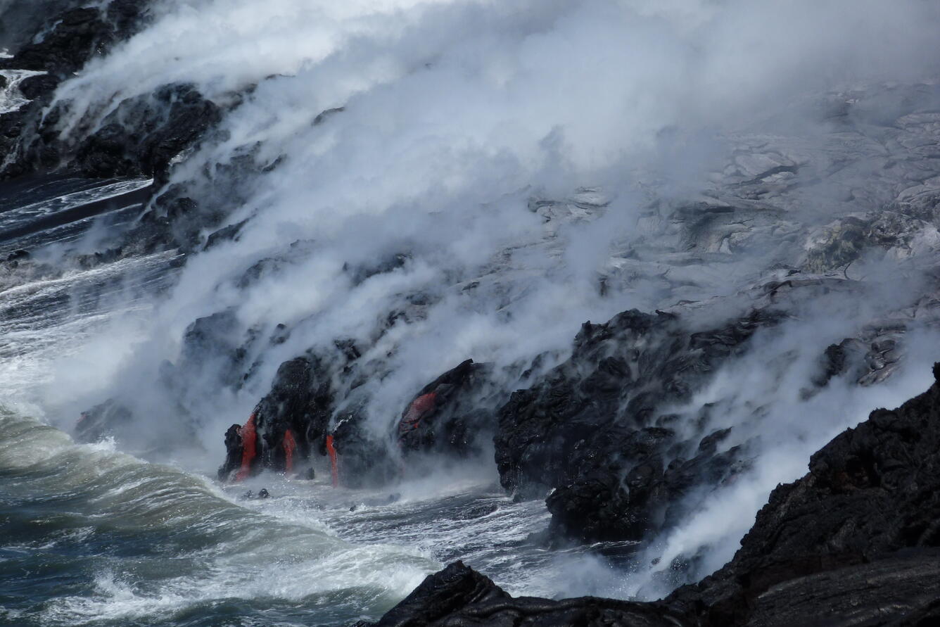 Close-up view (using a zoom lens from a safe distance) of lava stre...