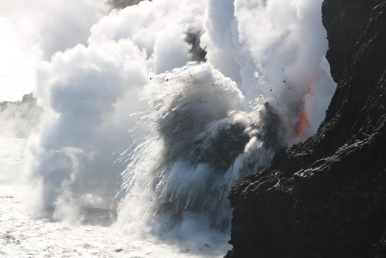 Using a telephoto lens, spatter and glassy rock fragments (black sa...