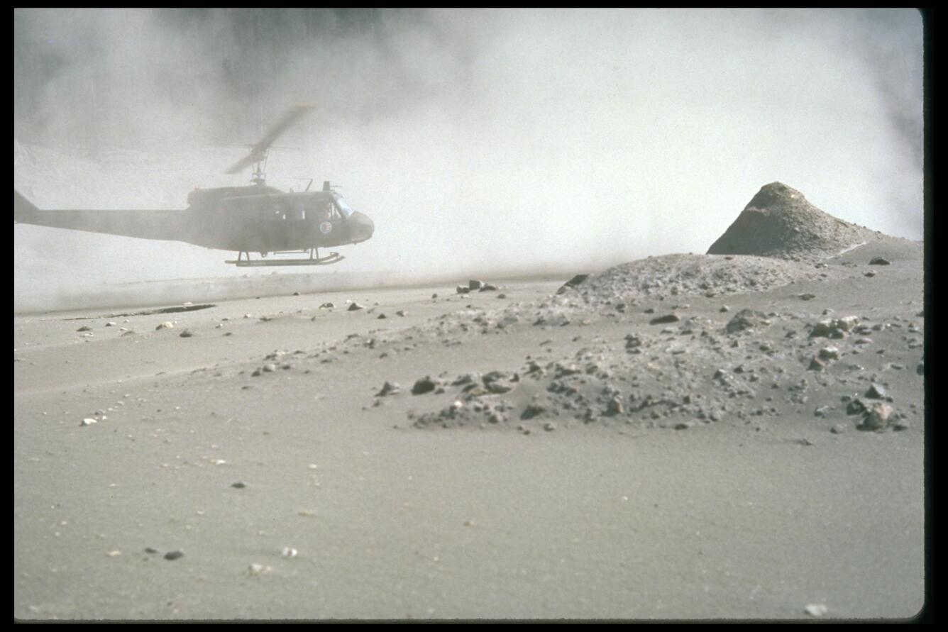 Helicopter stirs up ash while trying to land in the devastated area...