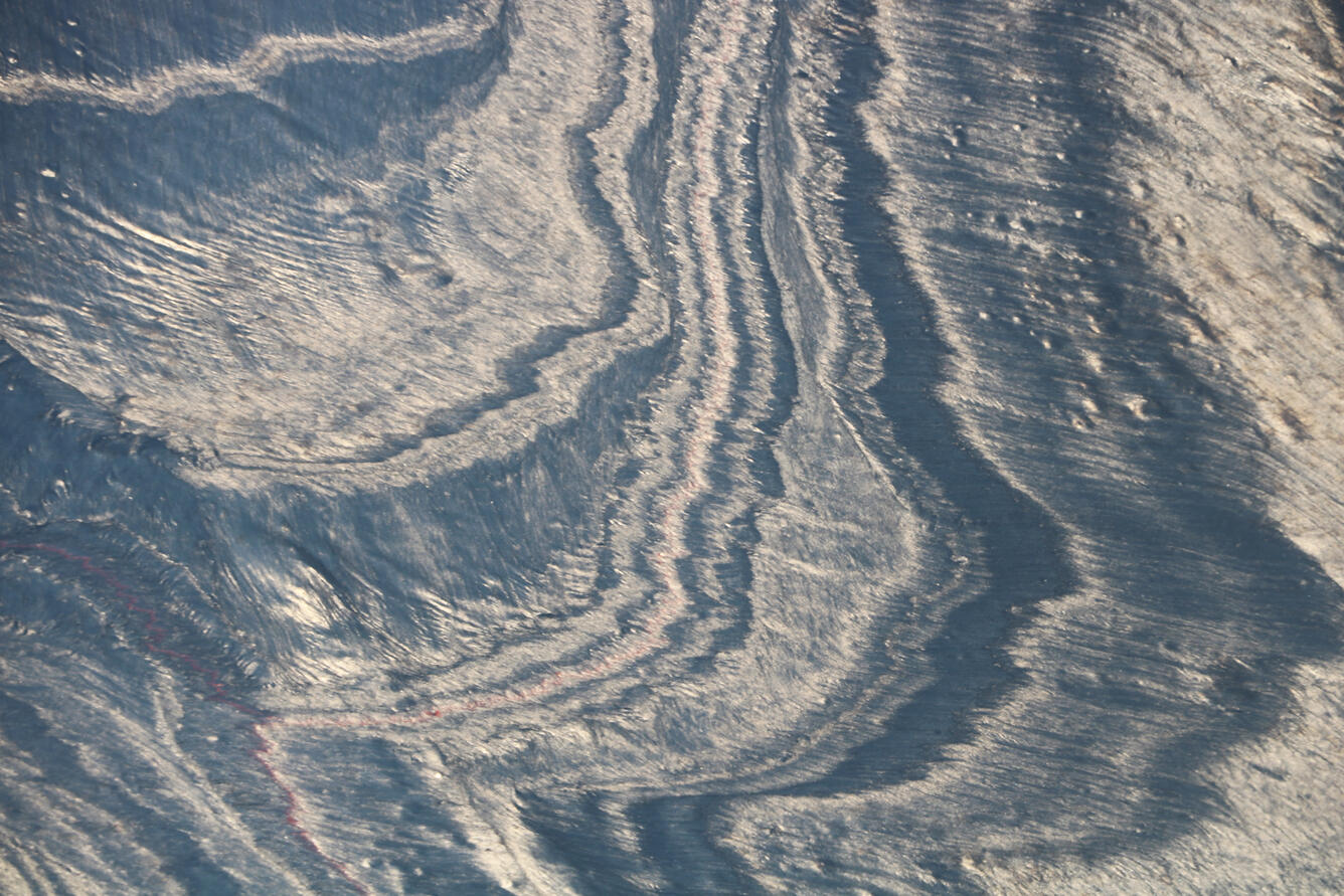 Crustal spreading zones leave bands of changing texture on the lava...