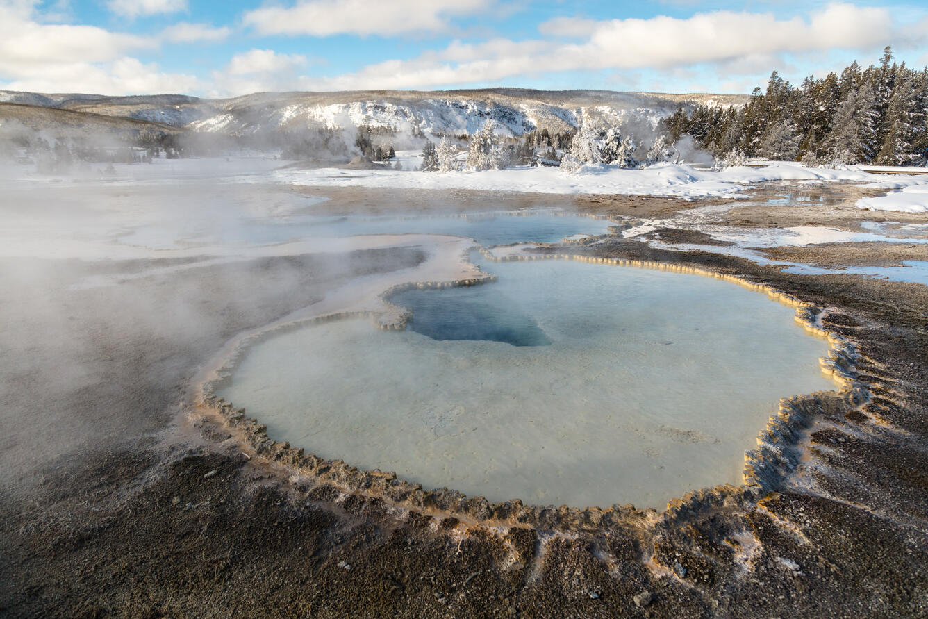 Doublet Pool, fringed by geyserite, in the Upper Geyser Basin of Ye...