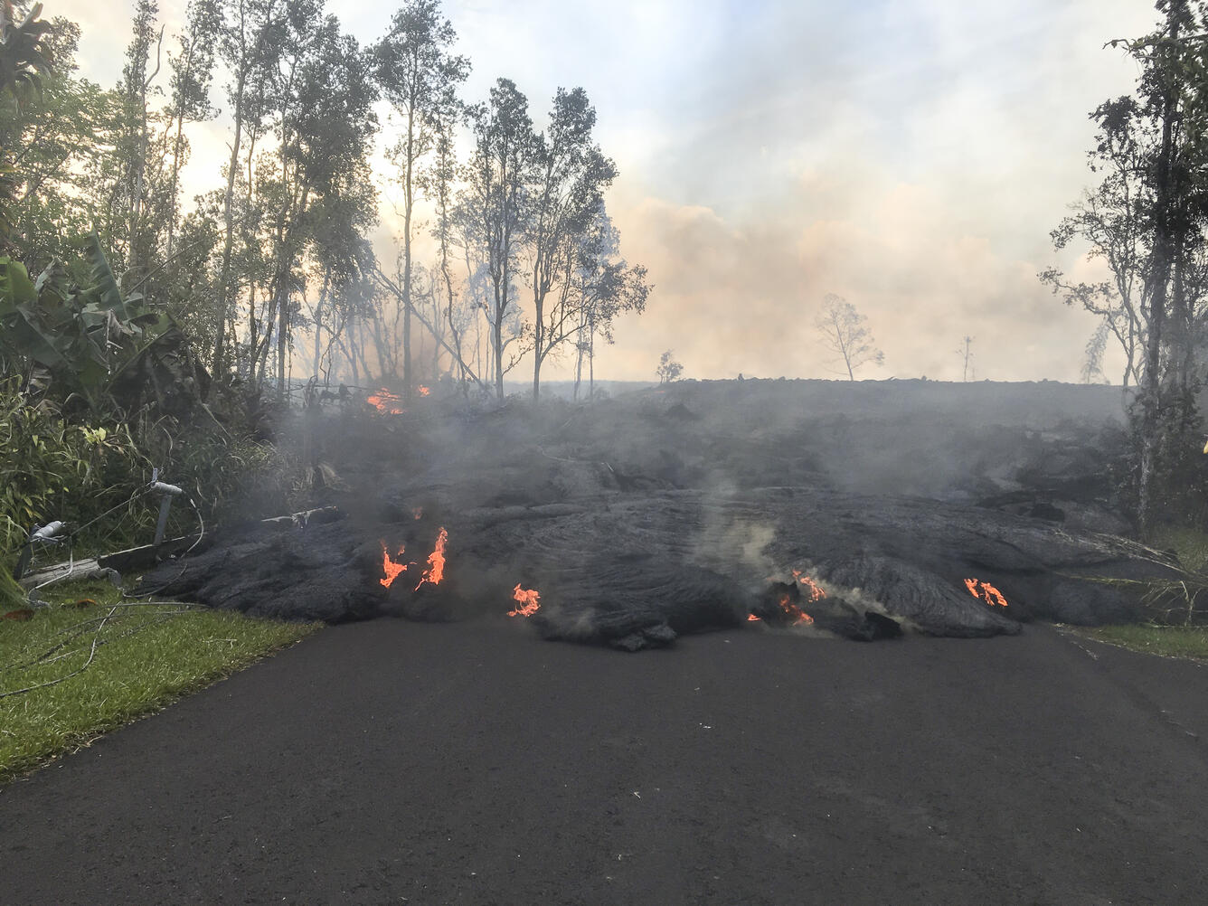 Lava from fissure 8 advances on Kahukai Street. Lava in this area i...