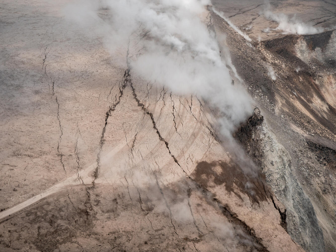 A closer view of the cracks cutting across the parking lot for the ...