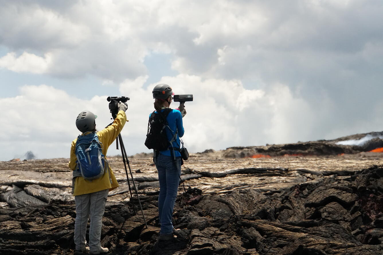 Field geologists Cheryl Ganescki and Sam Isgett make measuerments n...