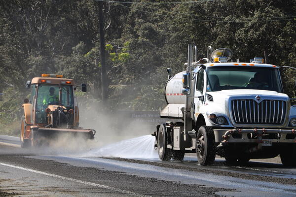 Color photograph of road being cleaned of tephra