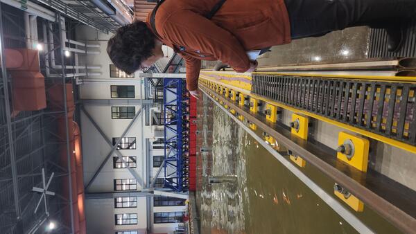 person gesturing into the experimental test basin at the HIF