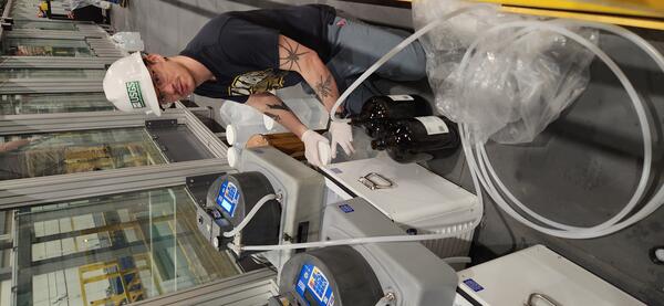 scientist collecting water samples in a hydraulics lab