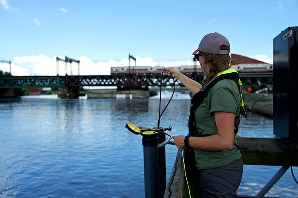 New England WSC hydrologic technician inspecting the continuous water quality monitoring equipment 