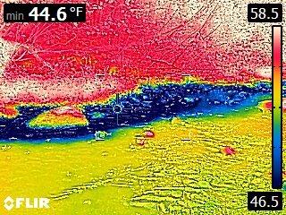A thermal image showing shades of blue as cooler temperatures and shades of red as warmer temperatures.