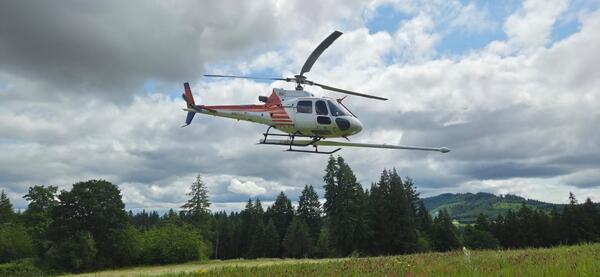 red and white helicopter with the “stinger” extending forward