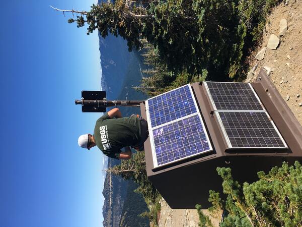 CVO Seismologist admires the view from atop a monitoring station after adjusting the solar panels. 