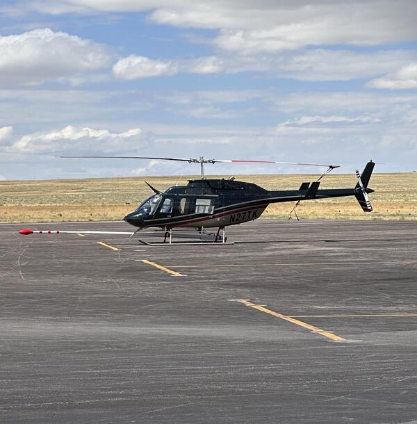 dark colored helicopter (N27TK) 