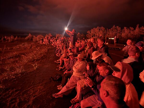 Color photograph of eruption viewers at night