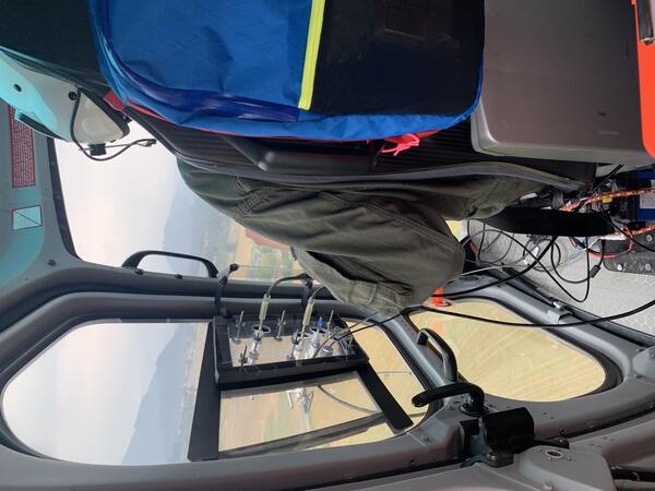 Color photo of the gas equipment looking out from the inside of the helicopter. 