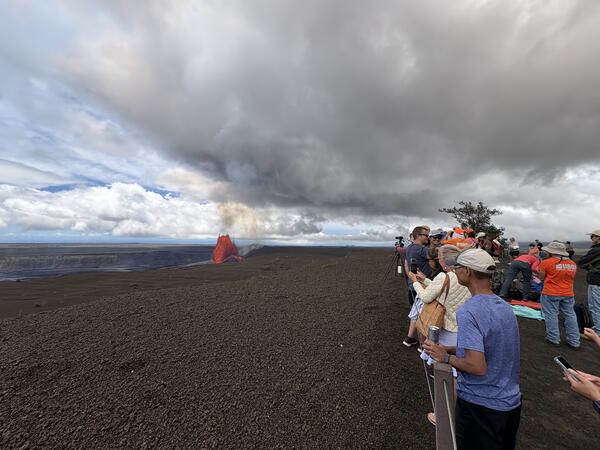 Color photograph of people viewing a volcanic eruption 