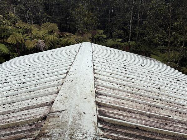 Color photograph of a roof with volcanic particles on it