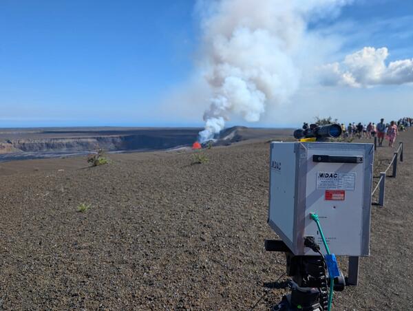 Volcano monitoring instrument pointed at a small lava fountain in crater