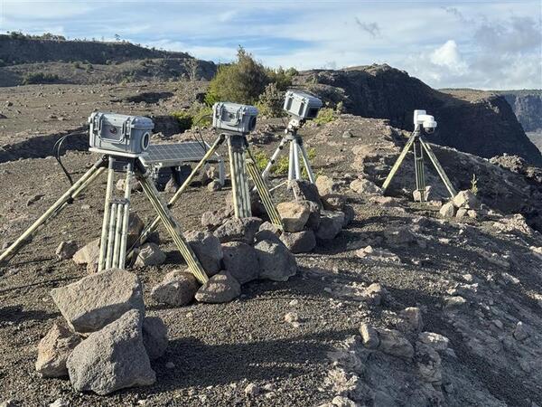 Color photograph of webcamera equipment perched on the edge of a crater