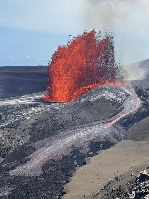 Color photograph of lava fountain and flow