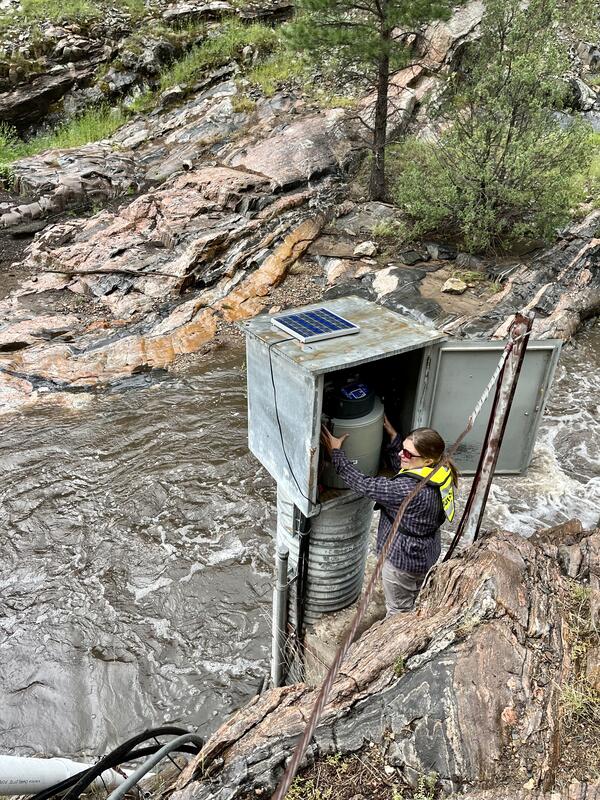 USGS Gallinas Creek near Montezuma, NM (08380500) streamgaging and water-quality monitoring station in August 2022 (watershed burned by Calf Canyon/Hermit Peak Fires April-August 2022) (photo showing Johanna Blake, USGS; photo by Jeannie Barlow, USGS)