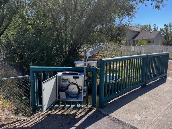Image of new gage attached to bridge in park.