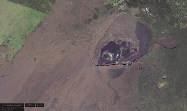 Color satellite image of a caldera at the summit of a volcano with deposits of different ages appearing different in color