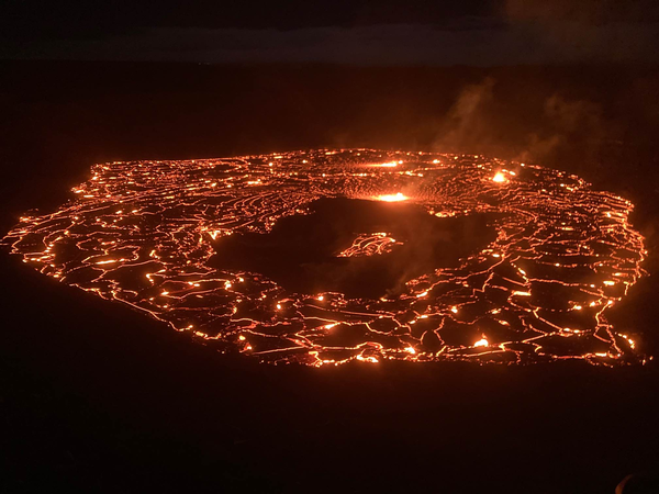 red and orange lava showing through cracks in blackened lava crust