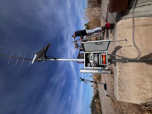Gage installation on concrete abutment on bank at bridge.