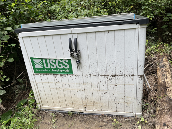 High water marks on a small shed/housing for equipment.