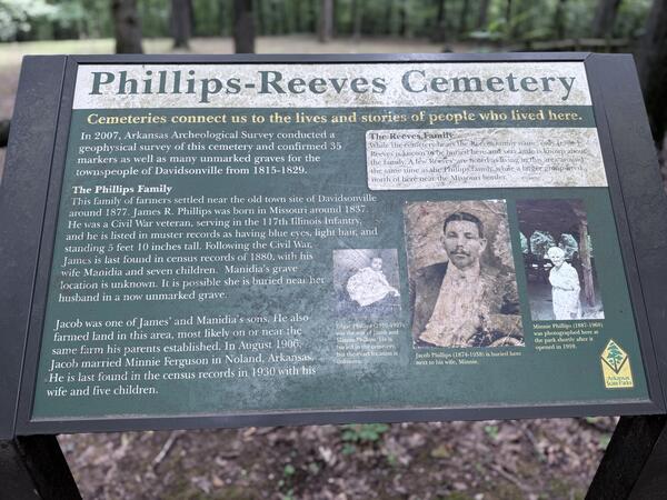 Informational sign about the Phillips‑Reeves Cemetery with text and historic photos.