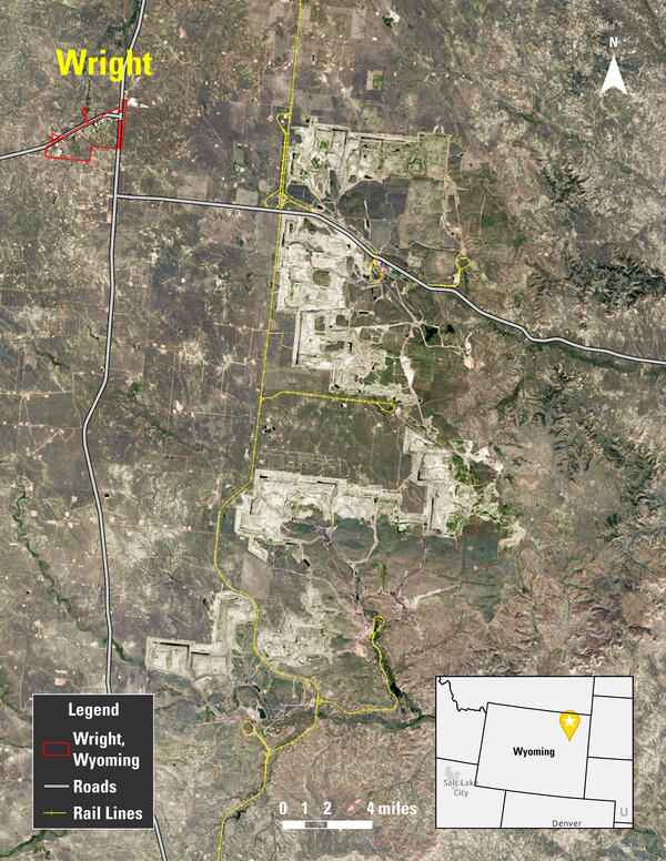 Map of an area with railroad tracks and roads indicated, along with a town and grassland areas