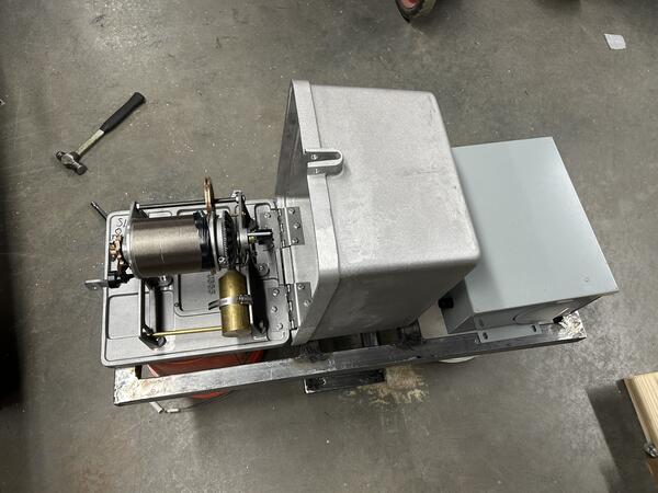 Equipment mount with reel and cover.