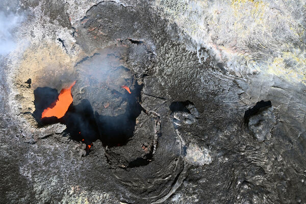Color photograph of volcanic vent with lava inside