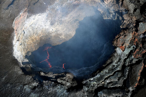 Color photograph of volcanic vent with lava 