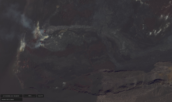 Color satellite image showing eruptive vents glowing red within a crater covered with dark colored lava flows
