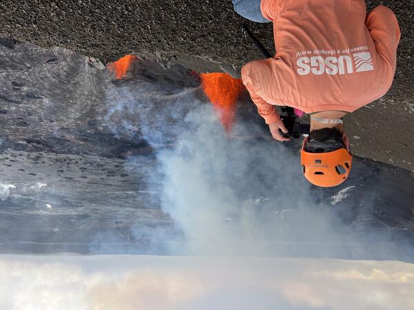 Color photograph of scientist monitoring eruption