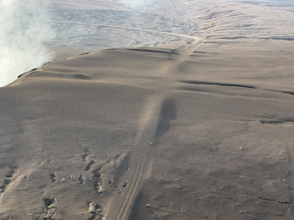 Color photograph of tephra blanket on road