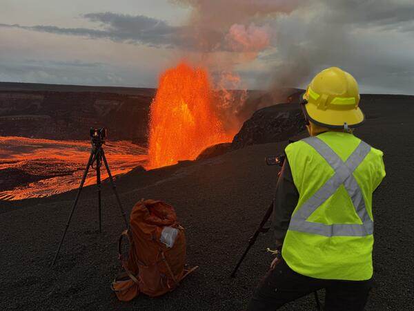 Color photograph of scientist monitoring eruption