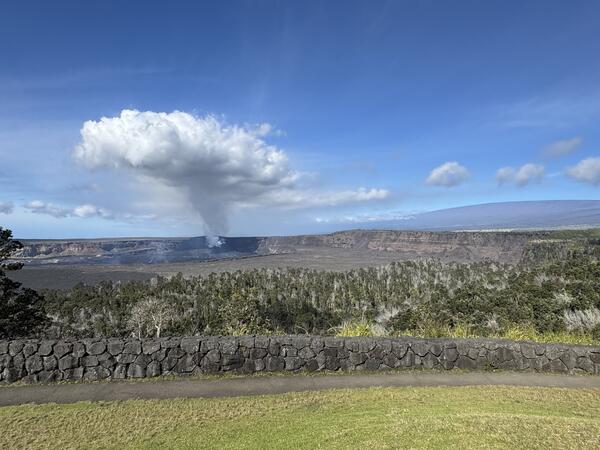 Color photograph of degassing plume above caldera